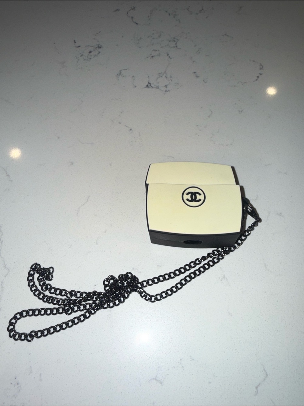 CC ivory and Black AirPods case 1st gen